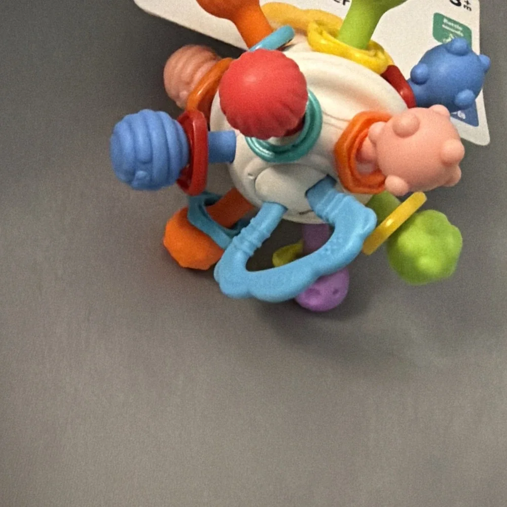 Nuby Textured Twist Ball Baby Teether Toy with Colorful Rattle